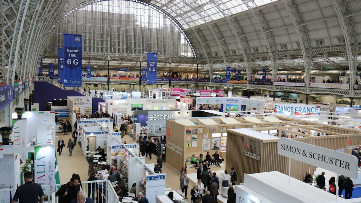 Busy exhibition hall with many booths and attendees