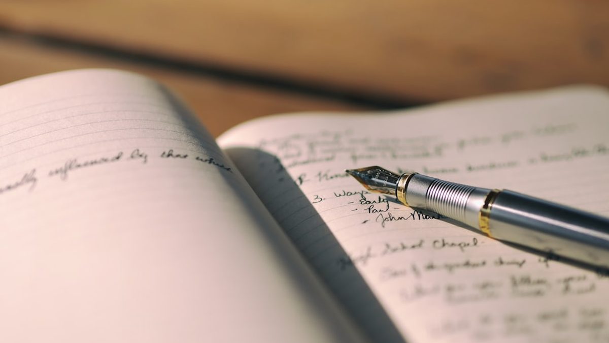 pen on white lined paper selective focus photography